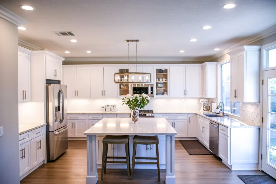 Spacious and elegant kitchen featuring white cabinetry, island, and stainless steel appliances